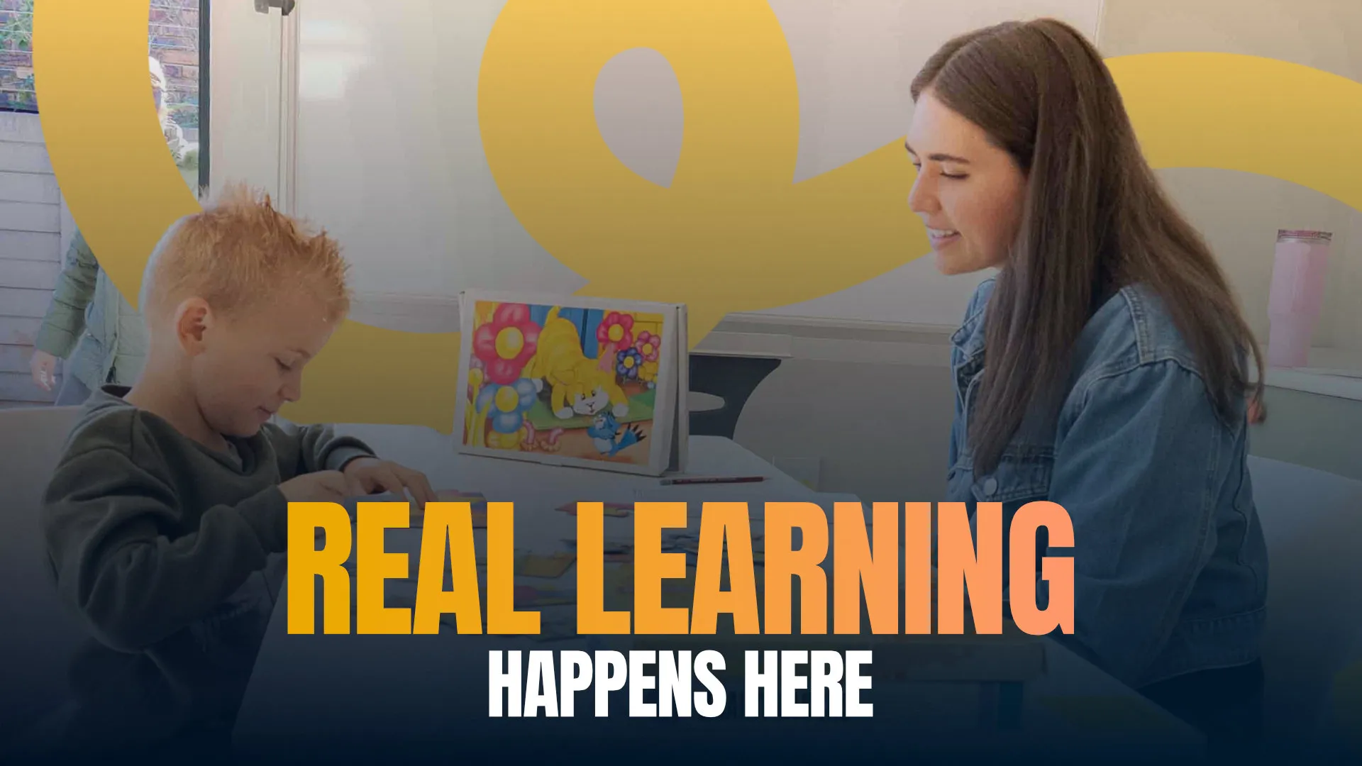 Real learning happens here — a facilitator and child working together at XCL